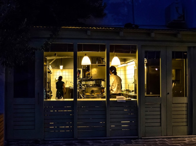 A lit storefront window at dusk, evoking the shift from static signage to living digital shopfronts