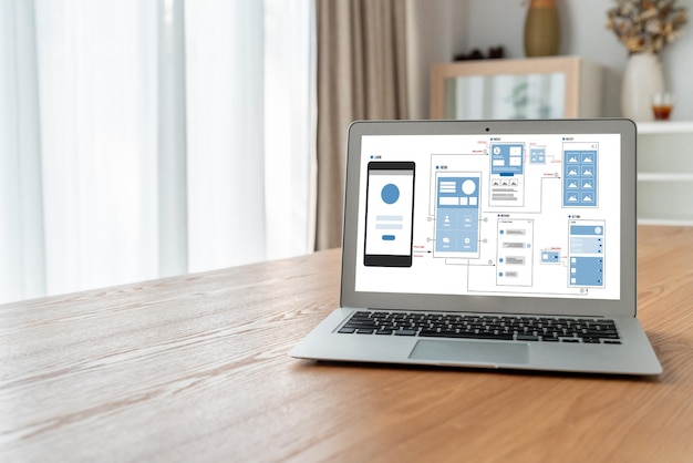 Phone displaying an app screenshot beside a laptop showing a related app being built