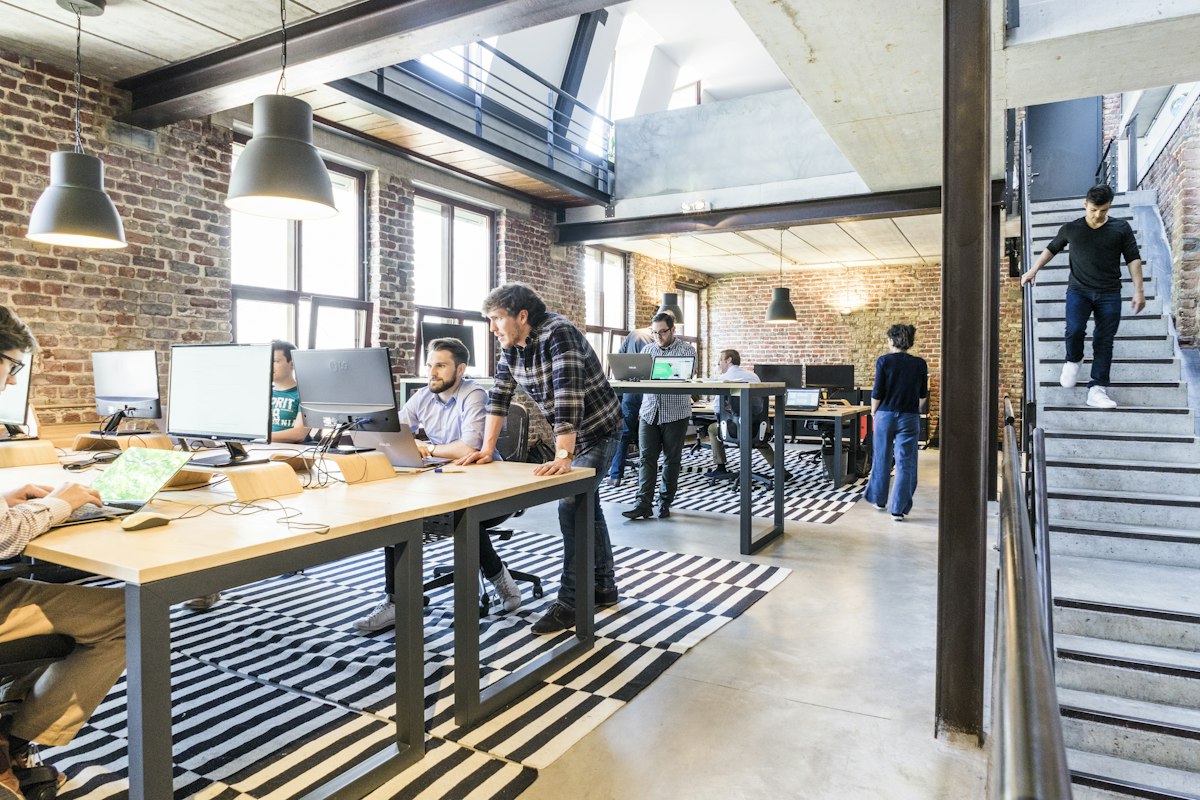 An energetic startup founder launching their product in a bright modern office space