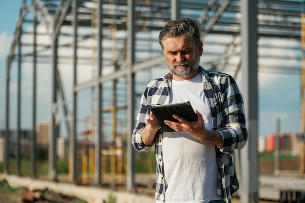 A small service business owner using a tablet while at their workplace