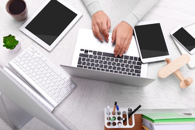 A small service business owner using a mix of mobile and laptop tools