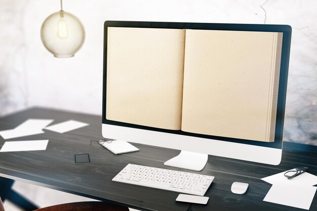 A printed handbook on a desk beside a laptop showing a clean knowledge base interface